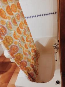 a shower curtain in a bathroom with a toilet at Casa Lucia in Mogarraz