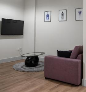 a living room with a couch and a table at Hereford City Centre - Apartment 2, Isabella House - Modern Apartment In The Heart of The City - Sleeps 2 Guests - Hosted by RENTMYHOUSE in Hereford