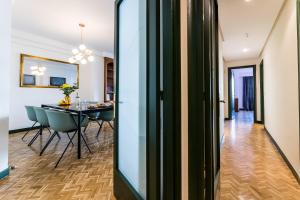 a dining room and living room with a dining table at ZUBIETA by SWEET HOME SAN SEBASTIAN in San Sebastián