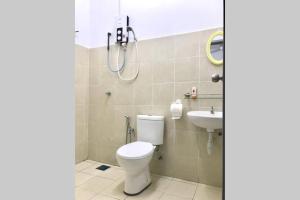 a bathroom with a toilet and a sink at Familyday homestay Port Dickson BBQ 3min to beach in Port Dickson +30 photos
