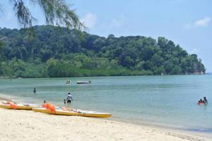 a group of people standing on a beach with boats at Familyday homestay Port Dickson BBQ 3min to beach in Port Dickson
