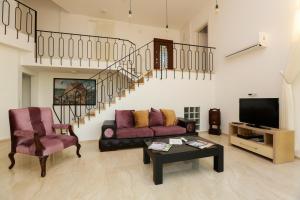 a living room with a couch and a table and a staircase at Villa Horizon in Dalyan