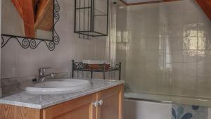 a bathroom with a sink and a shower at Saplan Real Estate ERA LANA in Les +19 photos