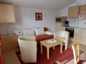 a living room with a couch and a table at Haus Sonnental in Filzmoos