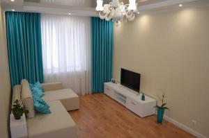 a living room with a couch and a flat screen tv at Apartment on Getmana Vigovskogo 49 in Rivne