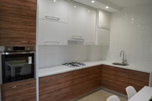 a kitchen with a sink and a stove top oven at Apartment on Getmana Vigovskogo 49 in Rivne +25 photos