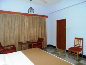 Postel nebo postele na pokoji v ubytování Hotel Bhimas Paradise