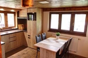 a kitchen and dining room with a table and chairs at Chata Styl in Hlinsko