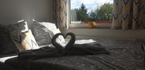 a swan blanket on a bed with a window at Apartment Nicole in Sundern