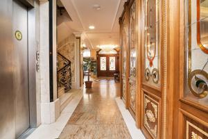 a hallway with wood paneled walls and a hallway with doors at Best Western Empire Palace Hotel & Spa in Istanbul