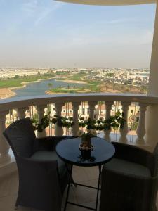 a balcony with a table and chairs and a view at Furnished studio in Al Hamra village with Lagoon view in RAK in Ras al Khaimah