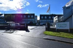 a parking lot with a sign in front of a building at North Devon Resort in Ilfracombe