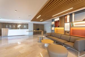 リスボンにあるHoliday Inn Lisbon by IHGのソファとテーブルが備わる待合室 +37枚の写真