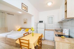 a kitchen and a dining room with a table in a room at Guest House Nenada in Dubrovnik