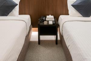 Letto o letti in una camera di Seiei Hotel Kyoto Kawaramachi