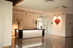 a lobby with a counter with a red heart on the wall at Hotel Rubin in Stara Blotnica