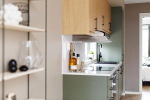 a kitchen with a counter and a stove top oven at BJØRVIKA APARTMENTS, Teaterplassen, Oslo city center in Oslo