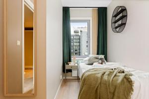 a bedroom with a bed and a mirror at BJØRVIKA APARTMENTS, Teaterplassen, Oslo city center in Oslo