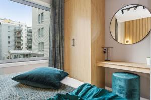 a bedroom with a window and a bed and a mirror at BJØRVIKA APARTMENTS, Teaterplassen, Oslo city center in Oslo