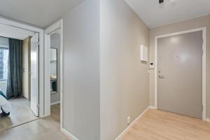 a room with a hallway with white walls and wooden floors at BJØRVIKA APARTMENTS, Teaterplassen, Oslo city center in Oslo