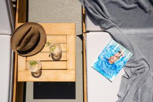 a hat and a picture of a person on a table at Edem Boutique Suites in Oia +129 photos