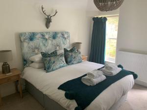 a bedroom with a bed with towels on it at Scarborough Hill Country Inn in North Walsham