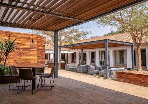 an outdoor patio with a table and chairs at The Doors Inn in Mokopane
