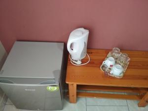 a table with a food processor and a blender at Georgios Rooms in Kalabaka