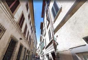 an alley between two buildings in a city at Borgo Pinti Cozy Flat in Florence