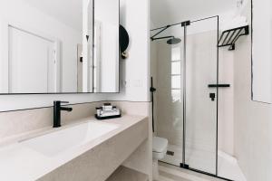 a bathroom with a sink and a shower at Soho Boutique Colón in Málaga +46 photos