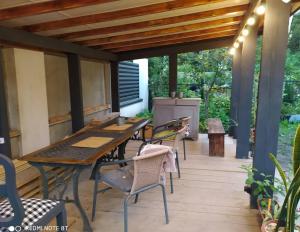 an outdoor patio with a wooden table and chairs at Flat in cottage close to the centre parking, WiFi, BBQ in Lviv