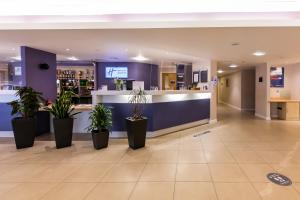 a lobby of a hospital with potted plants at Holiday Inn Express Norwich, an IHG Hotel in Norwich