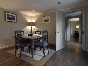 a dining room with a wooden table and chairs at Dunvegan Castle Rose Valley Cottage in Dunvegan