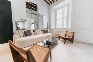 a living room with a couch and a table at Soho Boutique Colón in Málaga