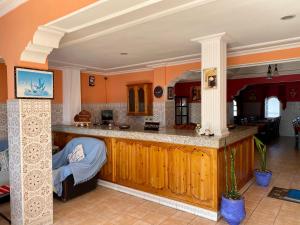 a kitchen with an island in a room at Le Lagon Bleu Oualidia in Oualidia