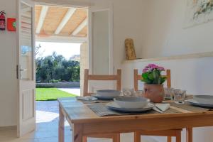 a wooden table with plates and bowls on it at Pajara Fazzadio in Lido Marini