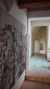 a room with a wall with photographs on the wall at Residenza delle Grazie in Miglionico