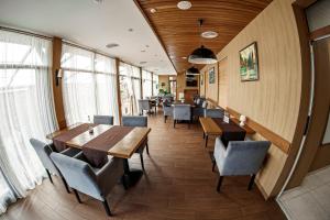 a dining room with wooden tables and chairs at Kolobok in Lutsk