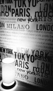 a stack of white cups in front of a wall of text at VIVER D'AMOR Oporto Douro River Flat in Vila Nova de Gaia