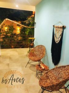 
a room with a table, chairs, and a rug at Los Arcos Tulum in Tulum
