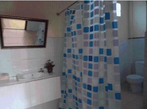 a bathroom with a sink and a shower curtain at Xuanmai Garden Resort in Pakse +41 photos