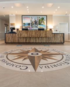 a large white clock sitting on top of a carpet at Compass Hotel by Margaritaville Anna Maria Sound in Bradenton