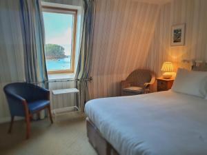 a hotel room with a bed and a window at Tigh an Eilean Hotel in Shieldaig