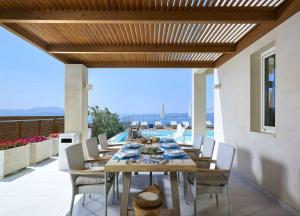 a wooden table and chairs on a patio at Deluxe Crete Villa Villa Apoi 4 bedroom villa Private Pool Sea Views Chania in Chania