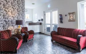 a living room with couches and a brick wall at Guesthouse Hamar in Vestmannaeyjar