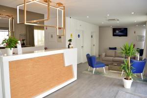 a lobby with a reception desk and a living room at Hotel Sol Algarve by Kavia in Faro