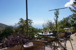 a table and chairs on a patio with a view at Kefalonia Sea View Cottage in Áno Váltai