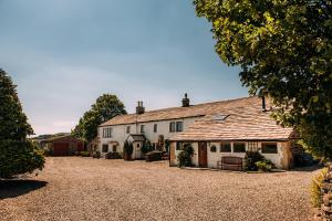 a large white house sitting on top of a gravel driveway at Laythams Holiday Lets Retreat in Slaidburn