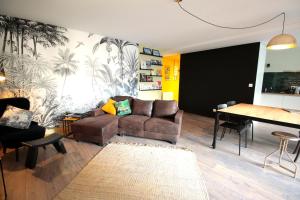 a living room with a couch and a table at Mon Appart A GERLAND II in Lyon