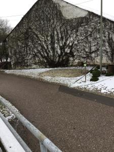 a stone wall with snow on the side of a road at Ferienwohnung Familie Heigemeir in Ehekirchen